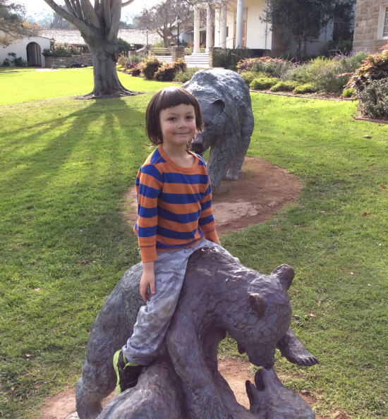 Riding the bear cubs at Colton Hall. Be careful young man!